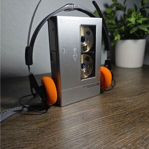 Sony Metallic Cassette Player with Bright Orange Headphones